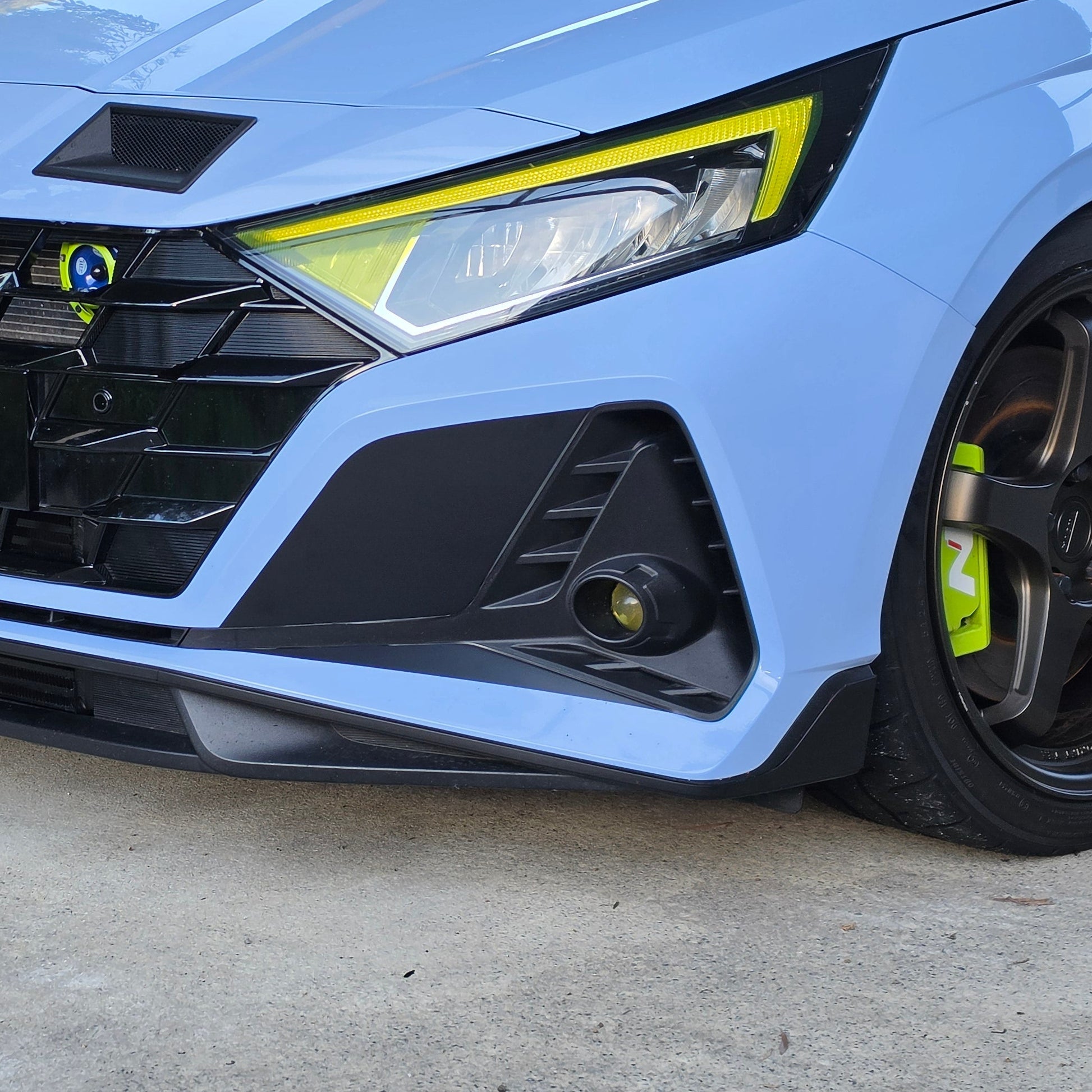 Close-up of i20N fog light blackout kit, matte black finish and clean edge